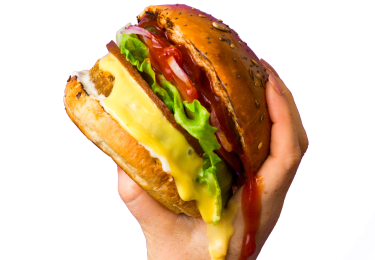 Vegan food holding dripping plant based burger